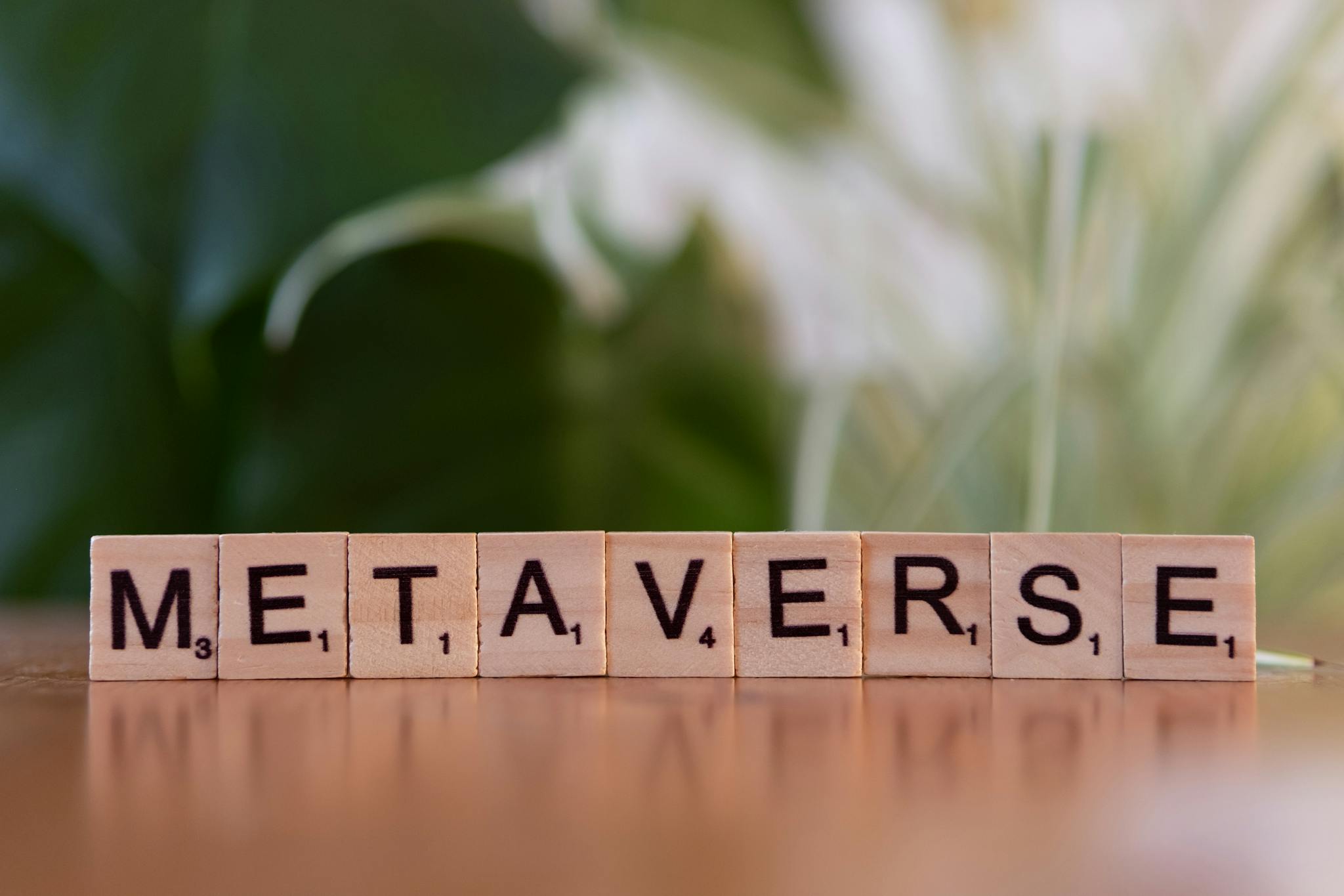 Scrabble letters spelling 'Metaverse' on a wooden surface with a blurred nature background.